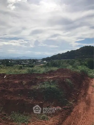 Scenic land plot with lush greenery and mountain views, perfect for development or investment opportunities.