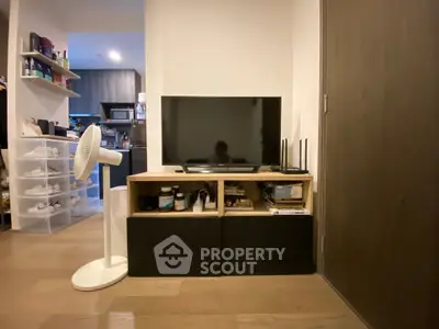 Cozy living room with modern TV setup and stylish storage solutions.