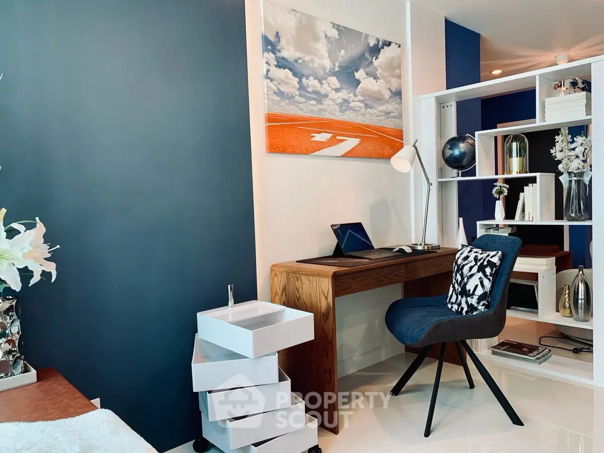 Modern study room with stylish desk, chair, and decorative shelving in a contemporary home.