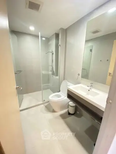 Modern bathroom with glass shower and sleek fixtures