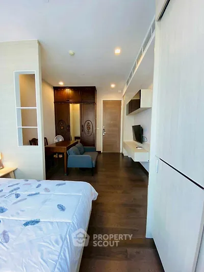 Modern bedroom with elegant decor and built-in storage in a stylish apartment.