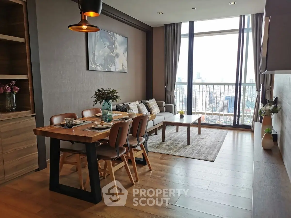 Modern living room with dining area and city view, featuring stylish decor and large windows.