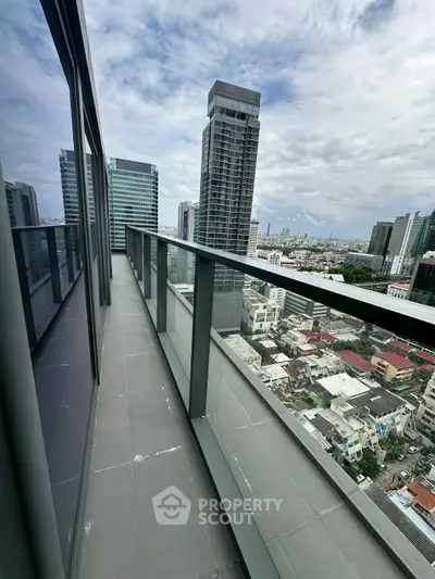 Stunning high-rise balcony with panoramic city views and modern glass railing.