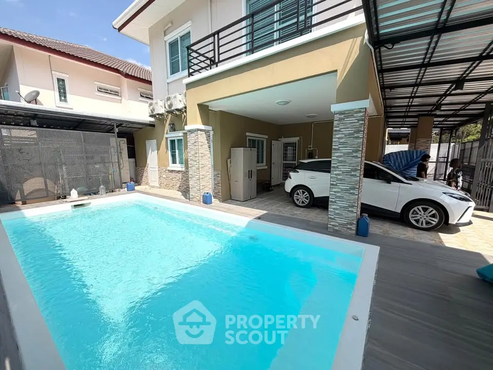 Modern home with private pool and covered parking in a sunny residential area.