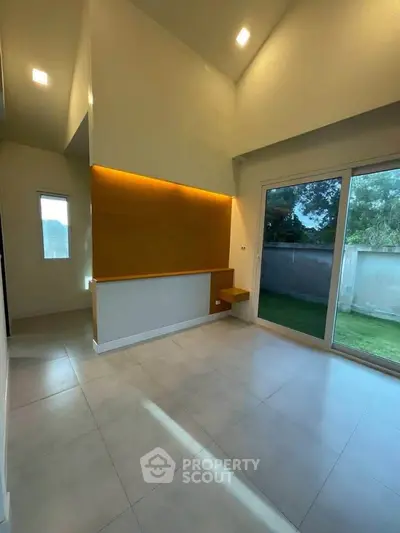 Spacious modern living room with large windows and garden view