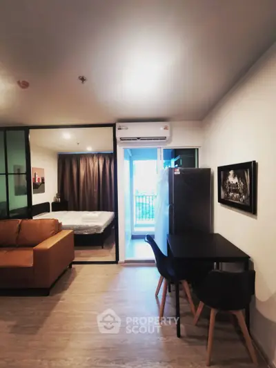 Modern studio apartment with open layout and balcony view