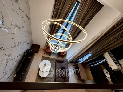 Luxurious modern living room with high ceilings and elegant lighting fixture