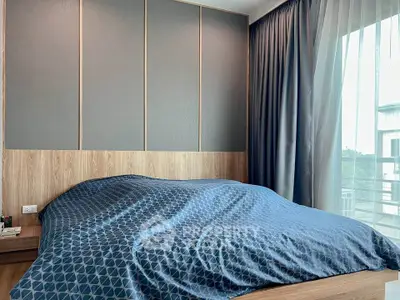 Modern bedroom with stylish decor and large window for natural light