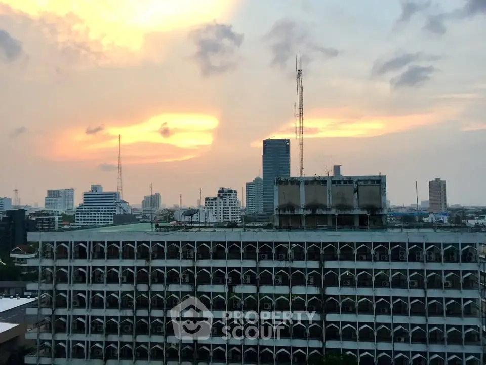 Stunning cityscape view with sunset sky and urban skyline, perfect for high-rise living enthusiasts.
