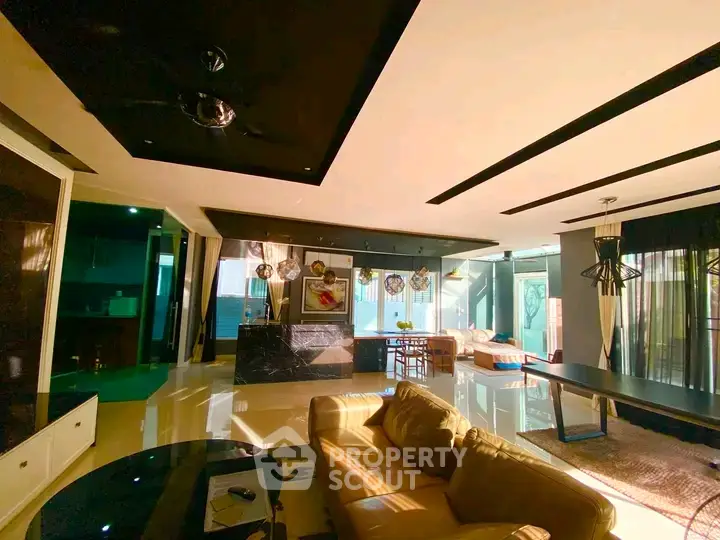 Luxurious open-plan living room with modern decor and ample natural light.