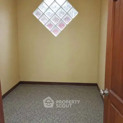 Cozy small room with unique diamond-shaped window and polished floor