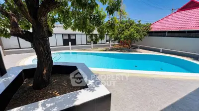 Stunning residential pool area with lush greenery and modern design.