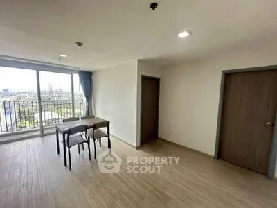 Spacious living room with large windows and balcony view