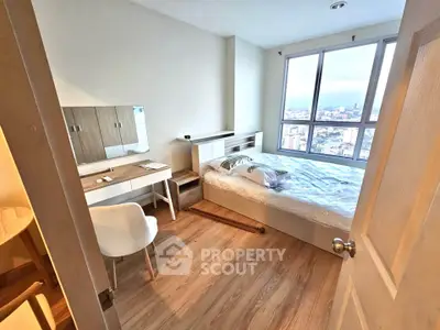 Cozy bedroom with city view, modern furniture, and natural light