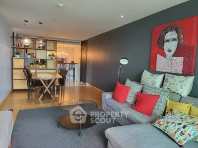 Stylish modern living room with open kitchen and colorful decor