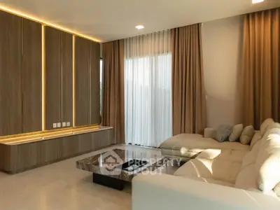 Luxurious living room with modern decor and large windows for natural light