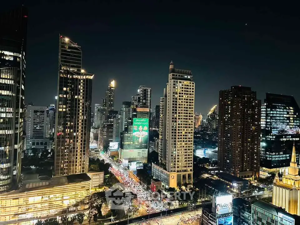 Stunning nighttime cityscape with illuminated skyscrapers and bustling streets.