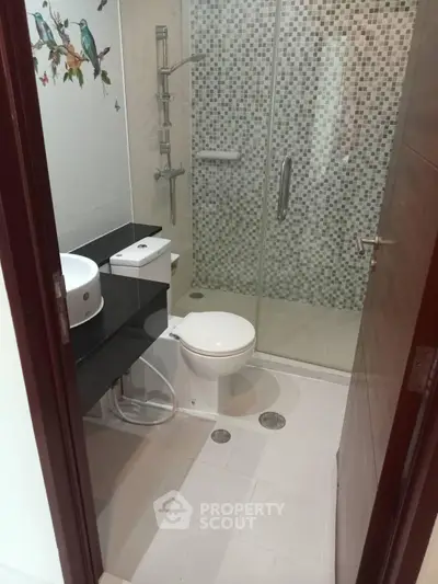 Modern bathroom with mosaic tile shower and sleek fixtures