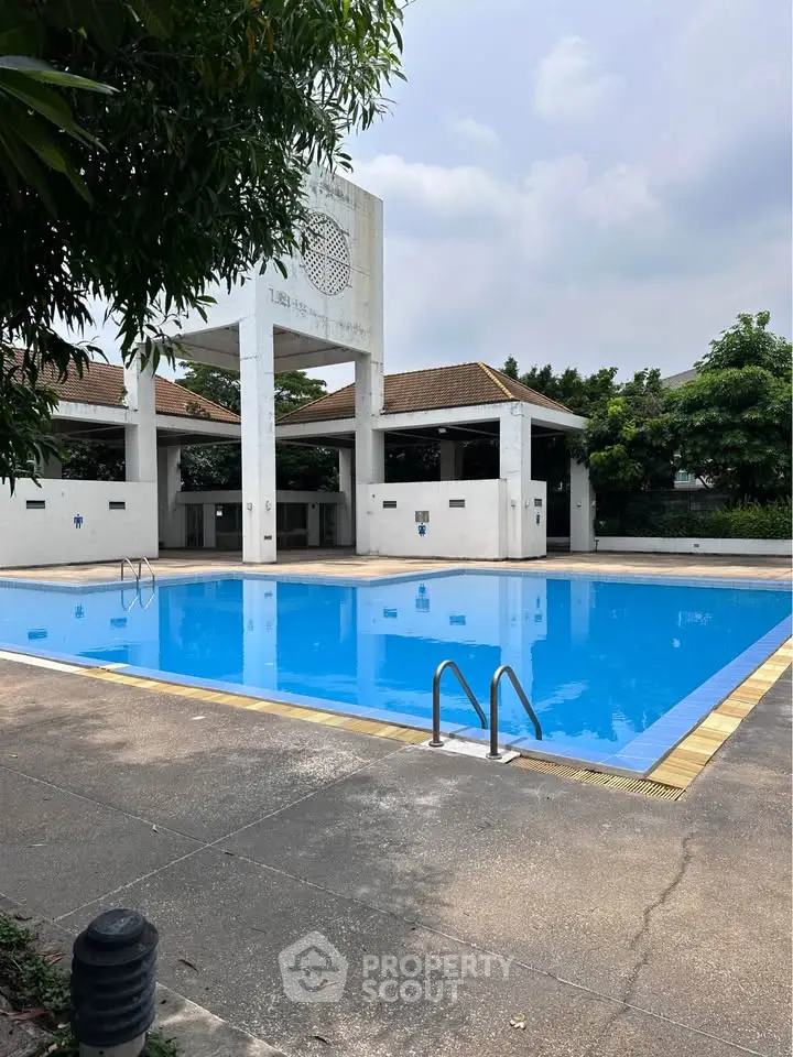 Stunning outdoor pool area with clear blue water and modern architecture, perfect for relaxation and leisure.