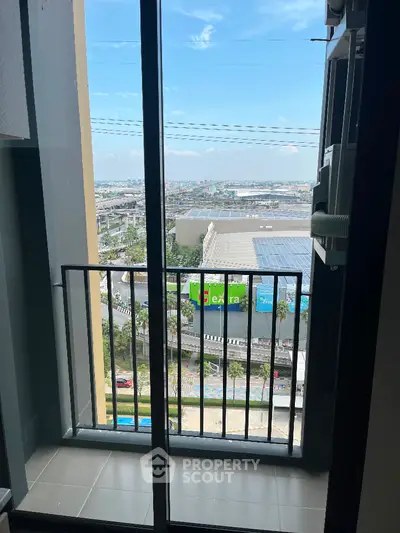 Modern apartment balcony with city view and glass railing