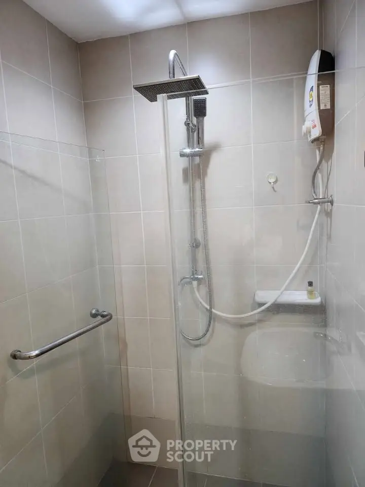 Modern bathroom with sleek shower and water heater in a tiled enclosure.