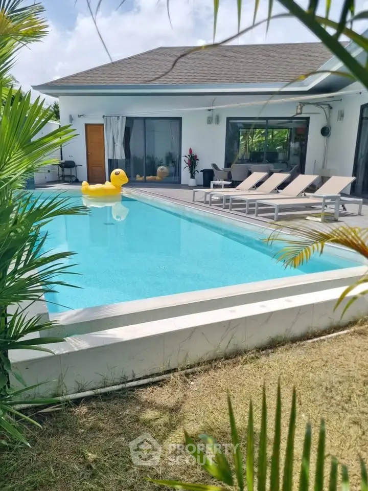 Luxurious villa with private pool and sun loungers, perfect for relaxation and leisure.