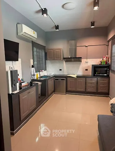 Modern kitchen with sleek cabinetry, stainless steel appliances, and ample counter space in a stylish home.