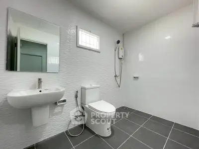 Spacious modern bathroom with sleek fixtures and tiled flooring