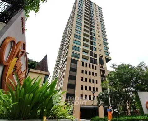Modern high-rise residential building with lush greenery and stylish architecture.