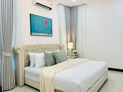Luxurious bedroom with elegant decor and plush bedding in a modern apartment.