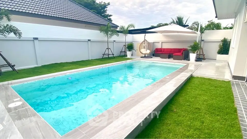 Luxurious backyard with pristine pool and stylish outdoor seating area