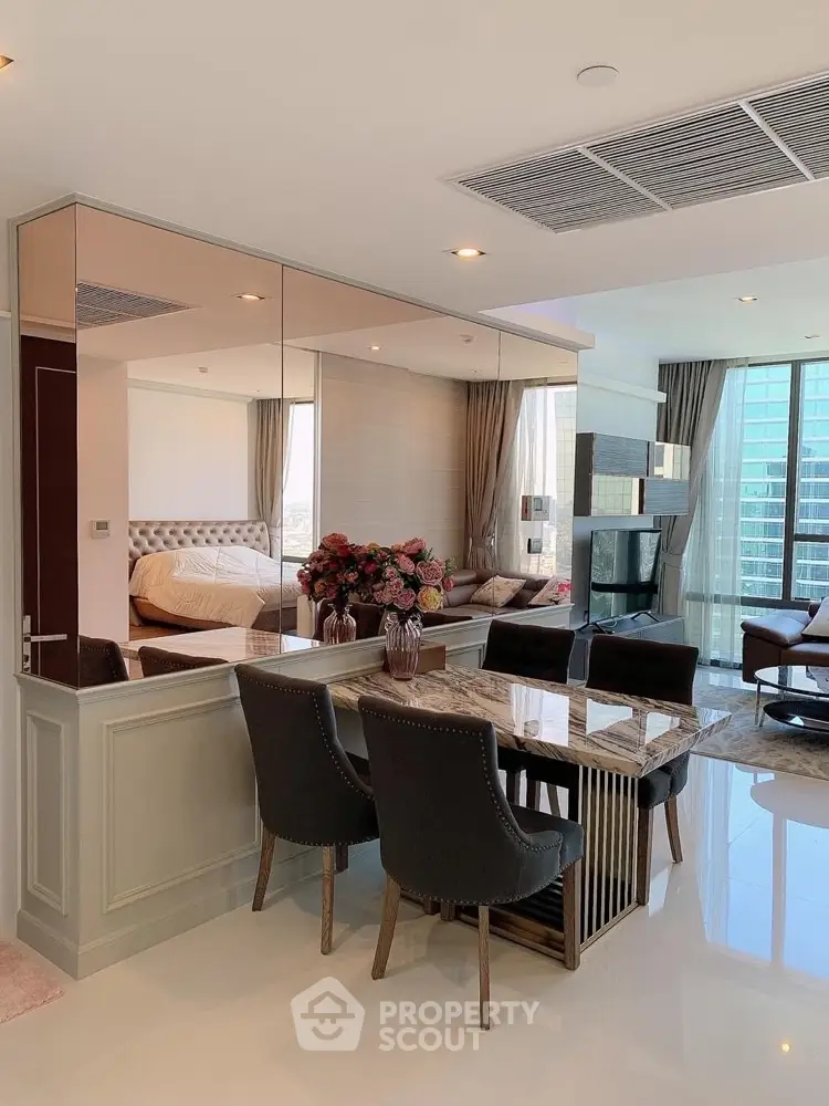 Luxurious open-plan living and dining area with elegant decor and city view