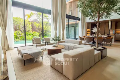 Luxurious open-plan living room with pool view and modern furnishings