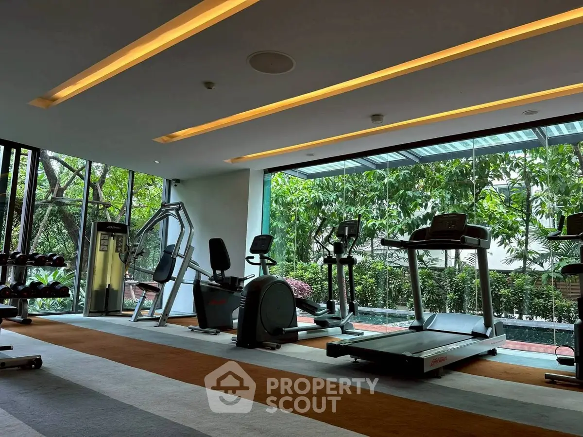 Modern gym with state-of-the-art equipment and lush garden view