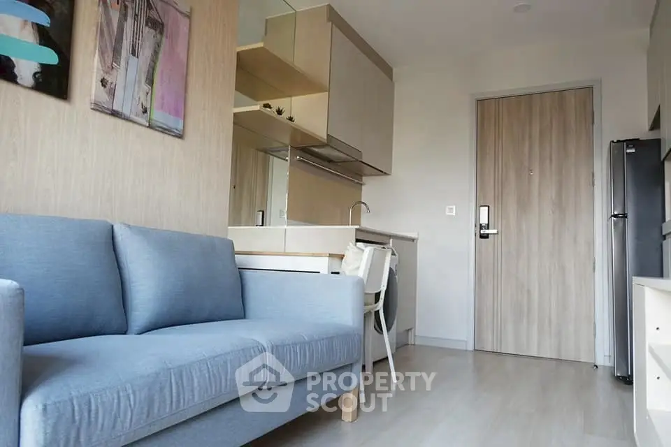 Modern compact living room with kitchenette and stylish decor