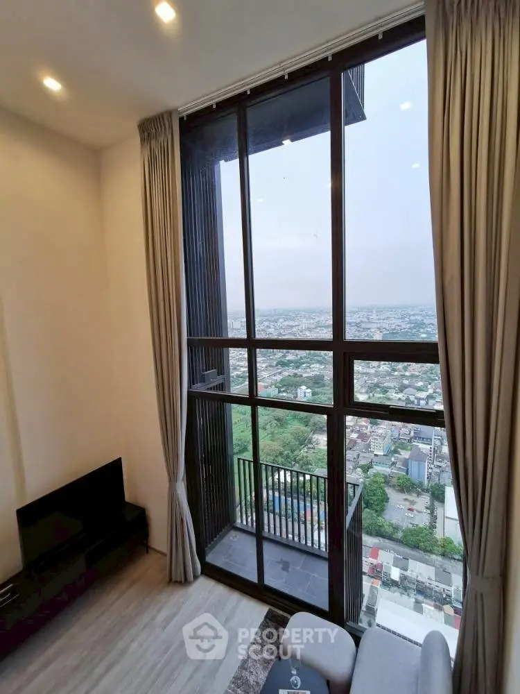 Stunning high-rise living room with floor-to-ceiling windows and breathtaking city view.