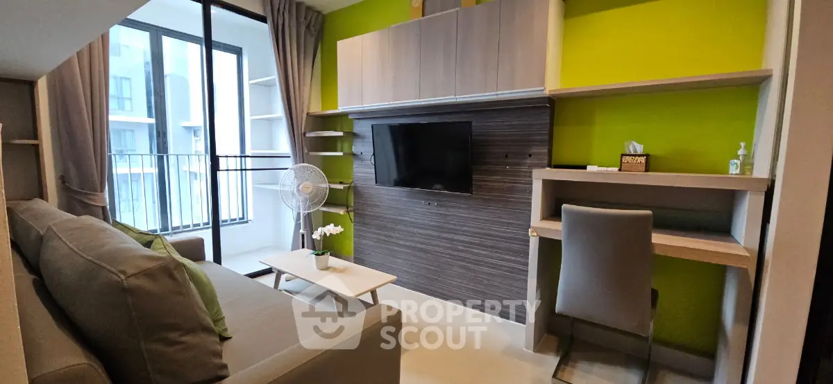 Modern living room with stylish decor, large window, and built-in entertainment center.
