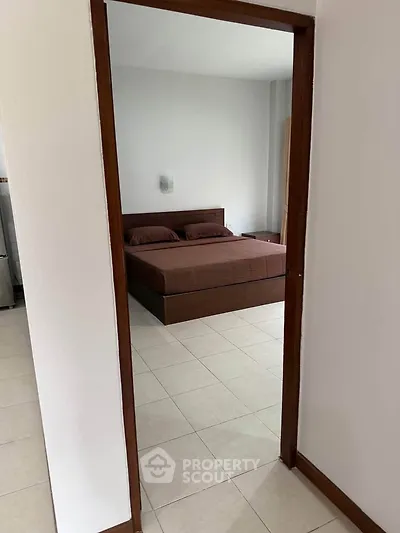 Spacious bedroom with modern decor and cozy ambiance in a stylish apartment.