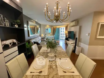 Luxurious dining and living area with elegant chandelier and marble table, perfect for entertaining.