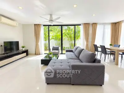 Spacious modern living room with large windows and elegant decor