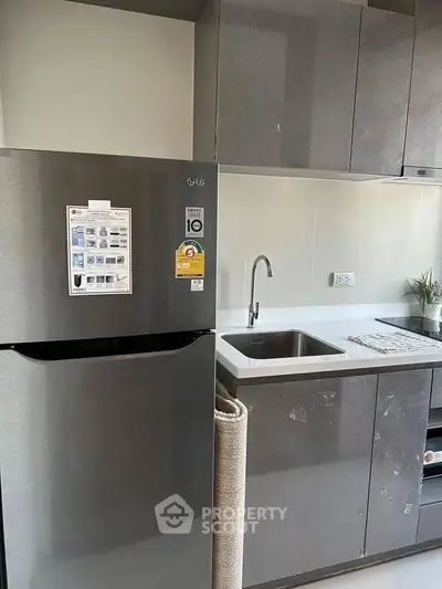 Modern kitchen with sleek cabinets and stainless steel fridge