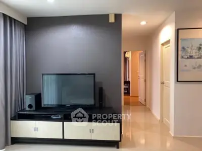 Modern living room with sleek TV stand and neutral decor, perfect for relaxation and entertainment.