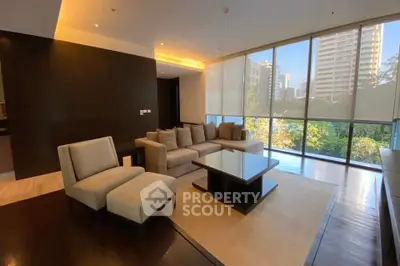 Luxurious living room with modern furniture and large windows offering a stunning city view.