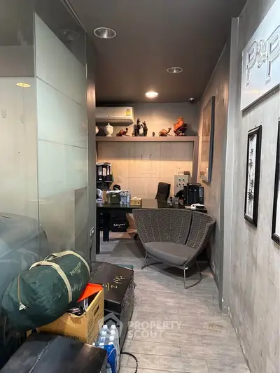 Compact office space with modern decor and glass partitions, ideal for small businesses or startups.