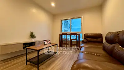 Modern living room with leather sofa and city view from window