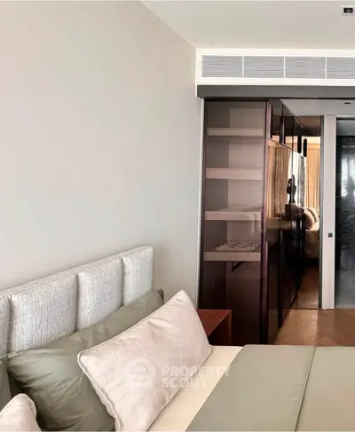 Modern bedroom with stylish headboard and sleek glass wardrobe design
