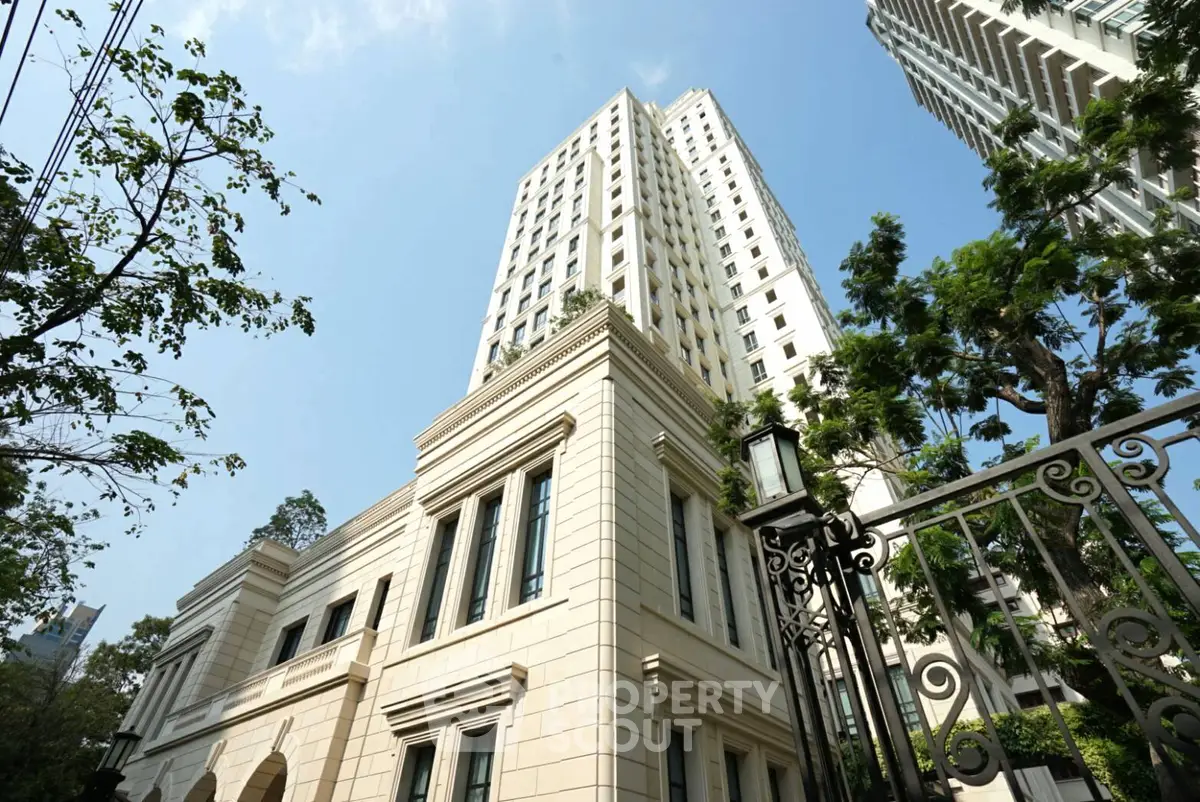 Elegant high-rise building with classic architecture and lush greenery, perfect for luxury urban living.