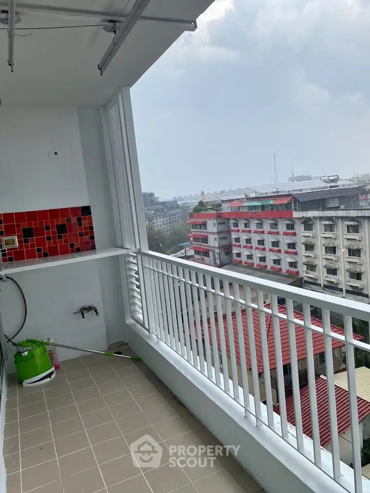 Spacious balcony with city view in modern apartment building
