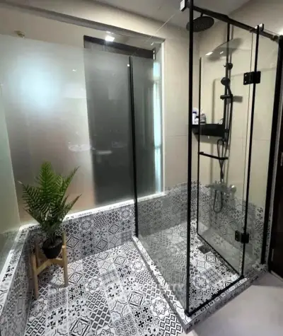 Stylish bathroom with modern glass shower and decorative tiles
