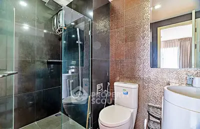 Modern bathroom with glass shower and sleek fixtures in contemporary apartment.